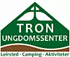Grønn logo for Tron Ungdomssenter med fjellform, kors og slagord om leirsted og camping