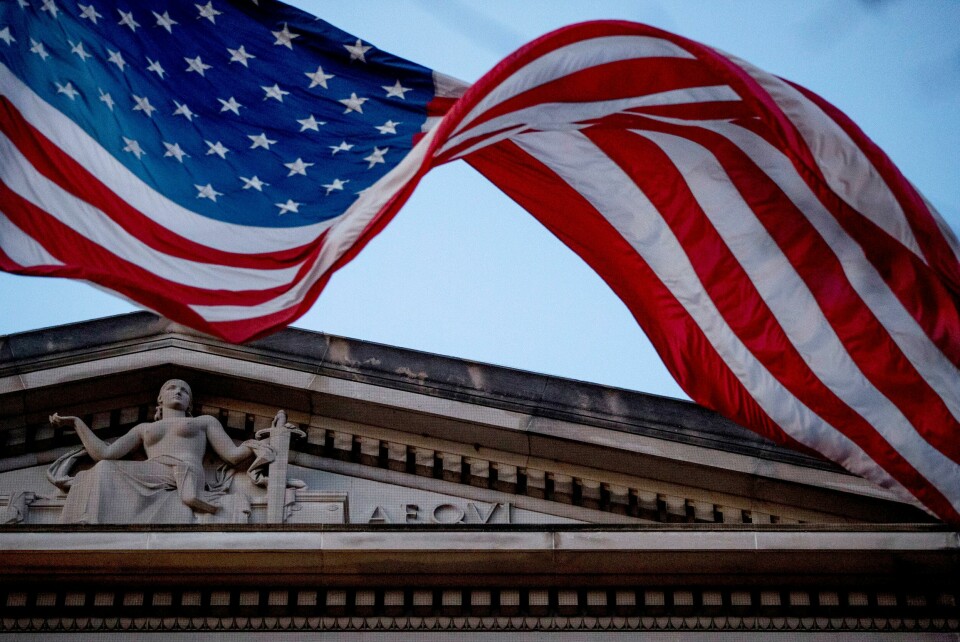 FILE - In this March 22, 2019 file photo, an American flag flies outside the Department of Justice in Washington. The Department of Justice says in a statement that hackers have been attempting to obtain intellectual property and public health data related to vaccines, treatments, and testing. (AP Photo/Andrew Harnik) FILE - In this March 22, 2019 file photo, an American flag flies outside the Department of Justice in Washington. The Department of Justice says in a statement that hackers have been attempting to obtain intellectual property and public health data related to vaccines, treatments, and testing. (AP Photo/Andrew Harnik)