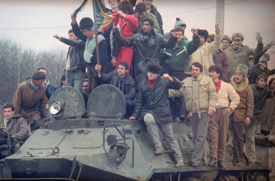 I desember 1989 pågikk det harde gatekamper mellom revolusjonære rumenere og Ceausescus styrker. På dette bildet, tatt lille julaften 1989 har rumenere i byen Timisoara klatret opp på en stridsvogn. Noen av dem gjør fredstegnet med hendene. To dager senere ble Ceausescu skutt og drept.