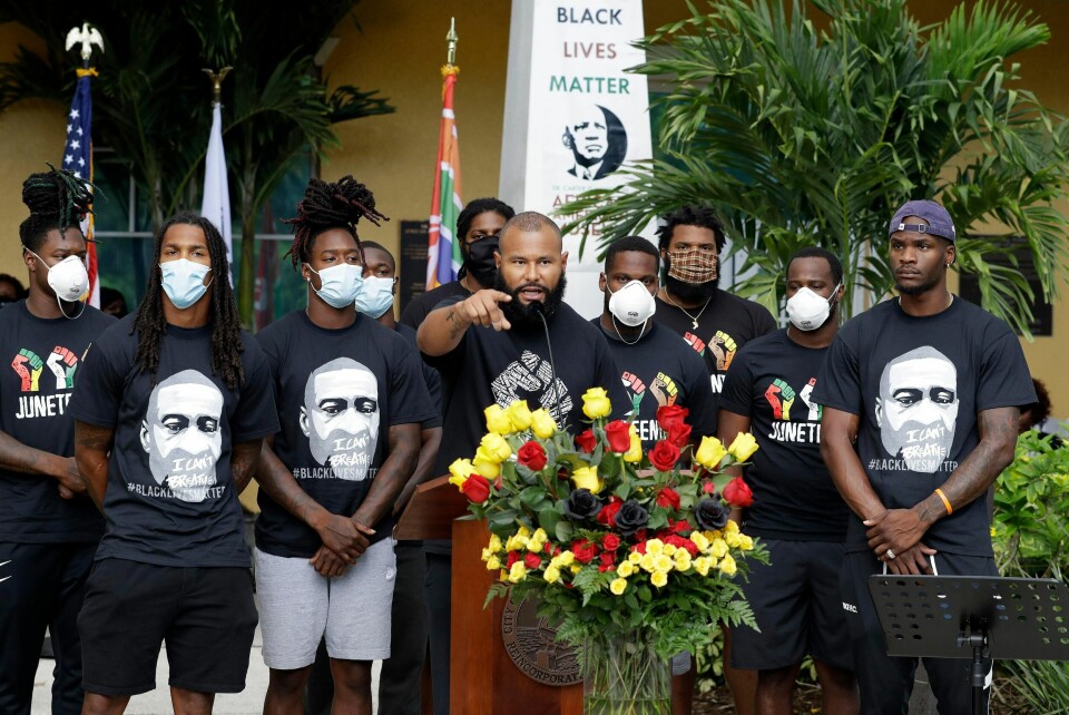 NFL football player Louis Murphy Jr., gestures as he stands with other professional ball players during a Juneteenth 2020 celebration outside the Dr. Carter G. Woodson African American Museum Friday, June 19, 2020, in St. Petersburg, Fla. Juneteenth marks the day in 1865 when federal troops arrived in Galveston, Texas to take control of the state and ensure all enslaved people be freed. (AP Photo/Chris O'Meara)
