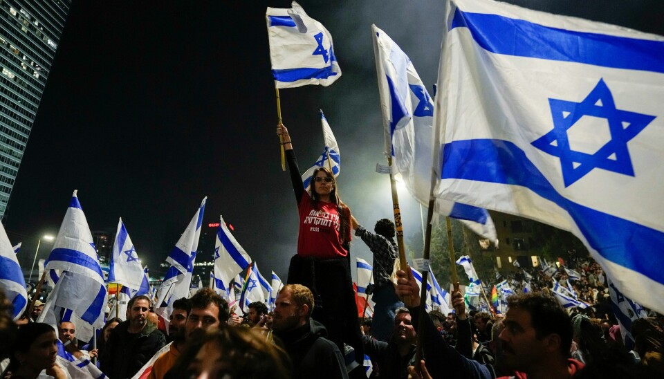 DEMONSTRASJONER: Det brøt ut nye protester en rekke steder i Israel etter at statsminister Benjamin Netanyahu sparket forsvarsminister Yoav Gallant, som ønsket å stanse regjeringens omstridte rettsreform. Nå krever president Isaac Herzog at reformen stanses. Det brøt ut nye protester en rekke steder i Israel etter at statsminister Benjamin Netanyahu sparket forsvarsminister Yoav Gallant, som ønsket å stanse regjeringens omstridte rettsreform. Nå krever president Isaac Herzog at reformen stanses. Foto: Ohad Zwigenberg / AP / NTB