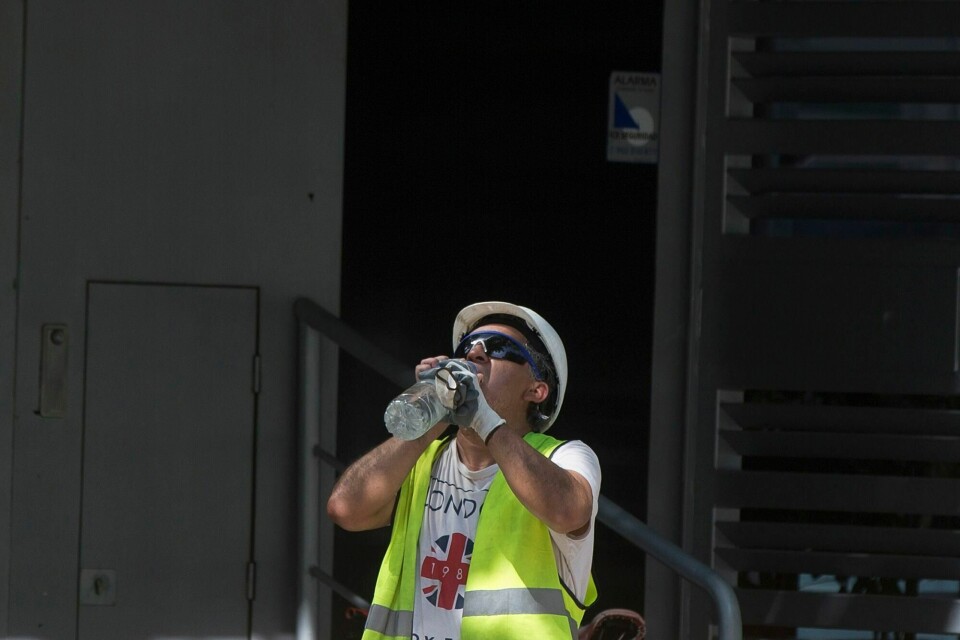 HETEREKORDER: En mann i arbeid stopper opp for å drikke vann i Madrid i Spania, sommer 2019. På dette tidspunktet satte flere steder i Europa heterekorder. A worker stops to drink from a bottle of water in Madrid, Spain, Thursday, July 25, 2019. Points across Europe are bracing for record temperatures Thursday as the second heat wave this summer bakes the continent. Climate scientists warn this could become the new normal in many parts of the world. But temperate Europe, where air conditioning is rare and isn't equipped for the temperatures frying the region this week. (AP Photo/Paul White)