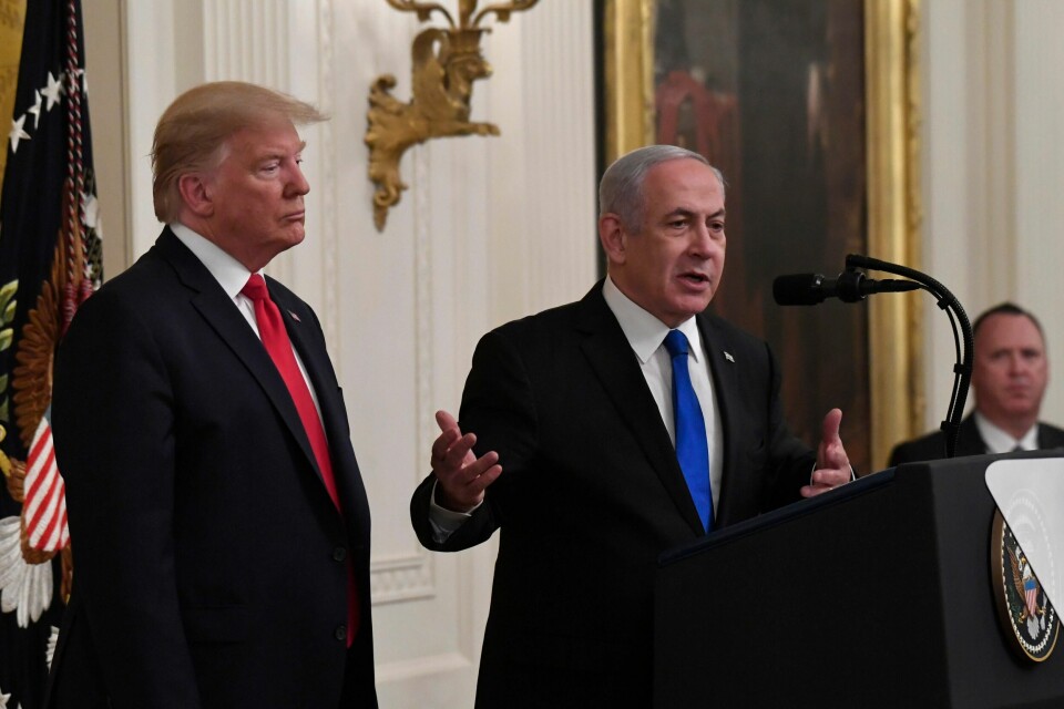 President Donald Trump, left, listens as Israeli Prime Minister Benjamin Netanyahu, right, speaks during an event in the East Room of the White House in Washington, Tuesday, Jan. 28, 2020, to announce the Trump administration's much-anticipated plan to resolve the Israeli-Palestinian conflict. (AP Photo/Susan Walsh)