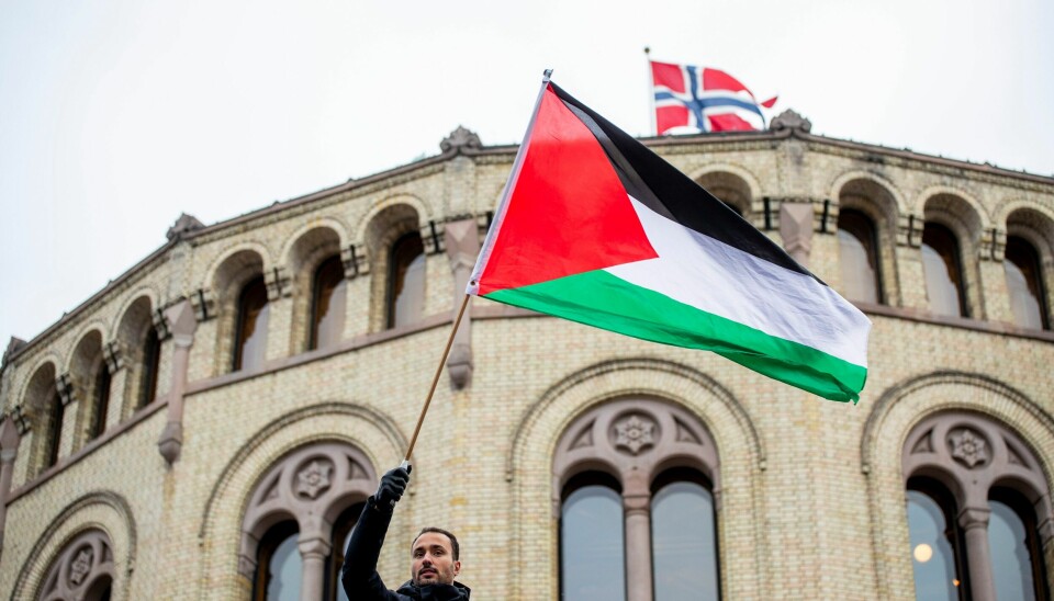 En demonstrant veiver med et palestinsk flagg utenfor Stortinget under en demonstrasjon i oktober i fjor. Foto: Frederik Ringnes / NTB