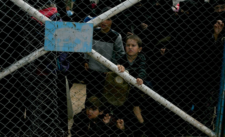 In this March 31, 2019 photo, children peer from the gate that closes off the section for foreign families who live in the Islamic State group's so-called caliphate, at Al-Hol camp in Hassakeh province, Syria. Al-Hol camp is home to 73,000 people who streamed out of the Islamic State groupÄôs last pockets, including the village of Baghouz, the final site to fall to the SDF in March. Nearly the entire population of the camp is women or children, since most men were taken for screening by the SDF to determine if they were fighters. (AP Photo/Maya Alleruzzo)