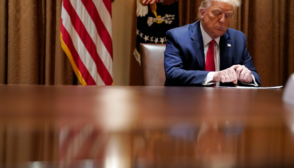 FILE - In this July 9, 2020, file photo President Donald Trump listens during a meeting with Hispanic leaders in the Cabinet Room, Thursday, July 9, 2020, in Washington. Republicans are trying to convince voters that the rare looting and violence that marred largely peaceful social justice protests foretell a wave of mayhem to come if Democrats are elected in November. Trump emphasized that menacing theme at the White House on Thursday, calling proponents of defunding the police crazy. Noting to a visiting group of Hispanic Americans that many immigrants had fled dangerous countries, Trump added, They know what happens when the police cannot protect the innocent, when the rule of law is destroyed. (AP Photo/Evan Vucci, File)