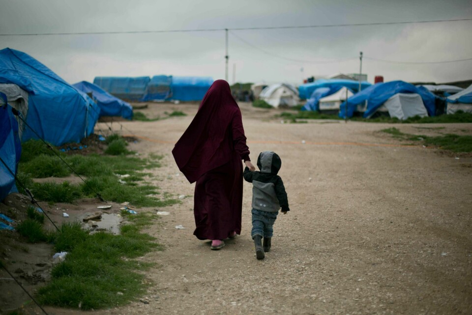 FILE - In this March 27, 2019, file photo, Samira, a Belgian national married to a French Islamic State member, Karam El-Harchaoui, walks with their son at Camp Roj in north Syria. 'I know he will not have a fair trial,' Samira told the AP at camp Roj, where thousands of foreign women and children are languishing. An Iraqi court on Tuesday, May 28, 2019 has sentenced two French militants, Karam El-Harchaoui and Brahim Nejara to death, bringing the total number of French former members of the Islamic State group condemned to the capital punishment this week to six. (AP Photo/Maya Alleruzzo, File)