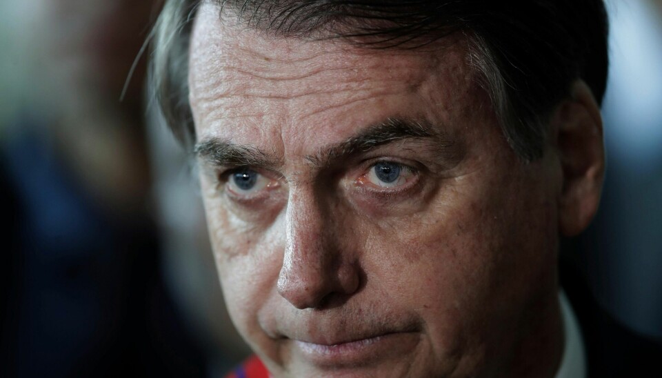 Brazil's President Jair Bolsonaro listens to a reporter's question at the end of a military ceremony where he was awarded the Order of Military Judicial Merit, in Brasilia, Brazil, Thursday, March 28, 2019. Bolsonaro, a former army captain who waxes nostalgic for the 1964-1985 dictatorship, on Monday asked BrazilÄôs Defense Ministry to organize Äúdue commemorationsÄù to mark the upcoming March 31st anniversary of BrazilÄôs 1964 military coup. (AP Photo/Eraldo Peres)