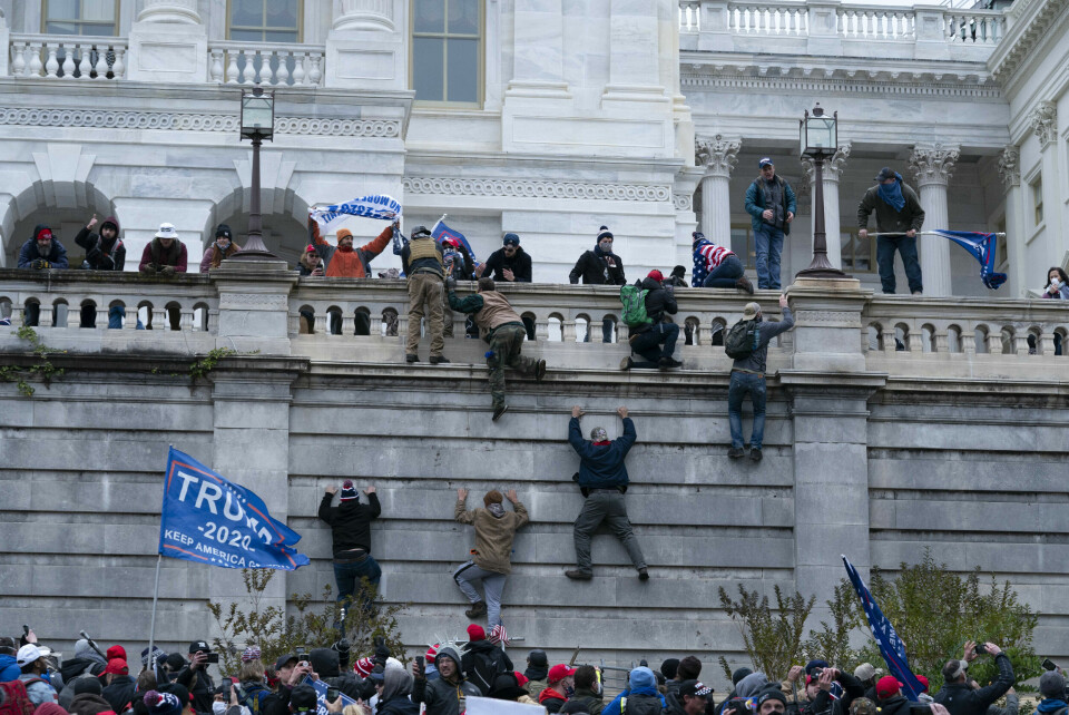 STORMING: Trump-supportere klatrer opp vestmuren til kongressbygningen i Washington 6. januar. FILE - In this Jan. 6, 2021, file photo, supporters of President Donald Trump climb the west wall of the the U.S. Capitol in Washington. There is increasing concern for the safety of journalists covering protests at state capitals across the U.S., and in Washington. Packing a gas mask and helmet has become the new normal. It's starting to look, just a bit, like what foreign correspondents face in the world's conflict zones. (AP Photo/Jose Luis Magana, File)