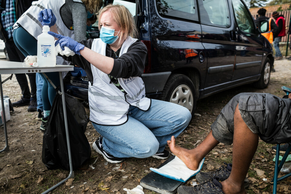 LEGEHJELP: Noleen, en britisk doktor og feltkoordinator for F.A.S.T. – First Aid Support Team i Calais, behandler skader på foten til en ung sudanesisk gutt i nærheten av Old Lidl, den største teltleiren i byen. 25. Noleen, en britisk doktor og feltkoordinator for F.A.S.T. – First Aid Support Team i Calais, behandler skader på foten til en ung sudanesisk gutt i nærheten av Old Lidl, den største teltleiren i byen.