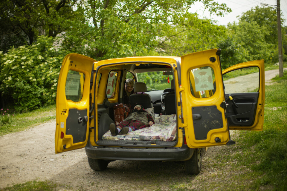 FRAKT: En eldre kvinne ligger på gulvet i en stasjonsvogn, på vei vekk fra kirgen. Organissjonen Vostok SOS er blant de som organiserer transport inn og ut fra krigsområdene. Evakuering Ukraina