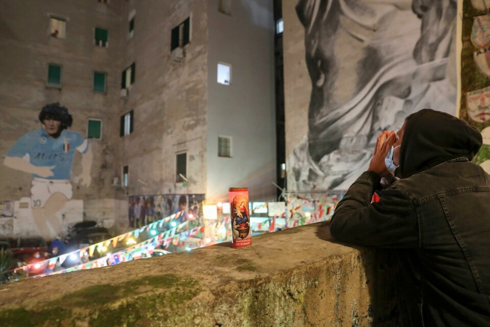 A man prays under a mural depicting soccer legend Diego Maradona, in Naples, Italy, Wednesday, Nov. 25, 2020. Diego Maradona has died. The Argentine soccer great was among the best players ever and who led his country to the 1986 World Cup title before later struggling with cocaine use and obesity. He was 60. (AP Photo/Salvatore Laporta) A man prays under a mural depicting soccer legend Diego Maradona, in Naples, Italy, Wednesday, Nov. 25, 2020. Diego Maradona has died. The Argentine soccer great was among the best players ever and who led his country to the 1986 World Cup title before later struggling with cocaine use and obesity. He was 60. (AP Photo/Salvatore Laporta)