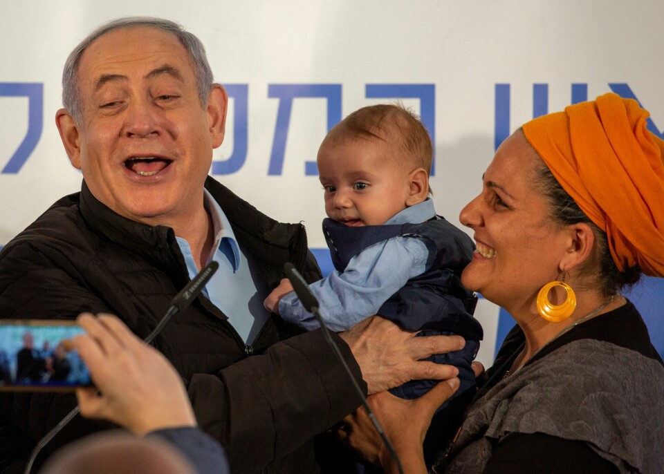 Israeli Prime Minister Benjamin Netanyahu is introduced to a baby named after him after planting a tree during an event on the Jewish holiday of Tu' BiShvat in the Jewish settlement of Mevo'ot Yericho, in the Jordan Valley near the Palestinians city of Jericho, Monday, Feb. 10, 2020. (AP Photo/Ariel Schalit) Israeli Prime Minister Benjamin Netanyahu is introduced to a baby named after him after planting a tree during an event on the Jewish holiday of Tu' BiShvat in the Jewish settlement of Mevo'ot Yericho, in the Jordan Valley near the Palestinians city of Jericho, Monday, Feb. 10, 2020. (AP Photo/Ariel Schalit)